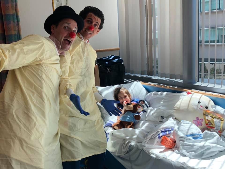 Two Red Nose Docs at a patient's bedside.